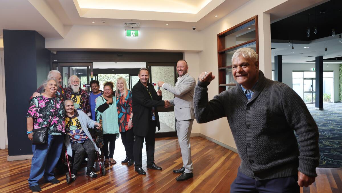 Illawarra Aboriginal Corporation board members and CEO William Henry receive they keys to the building from MMJ director Tim Jones. Picture by Sylvia Liber 