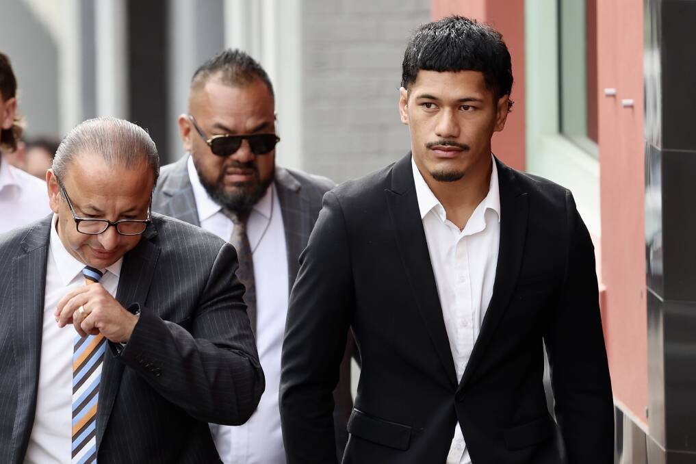 Ex-NRL player Junior Amone outside Wollongong courthouse last year with defence lawyer Elias Tabchouri (left) and father Senior Amone (behind). Picture by ACM