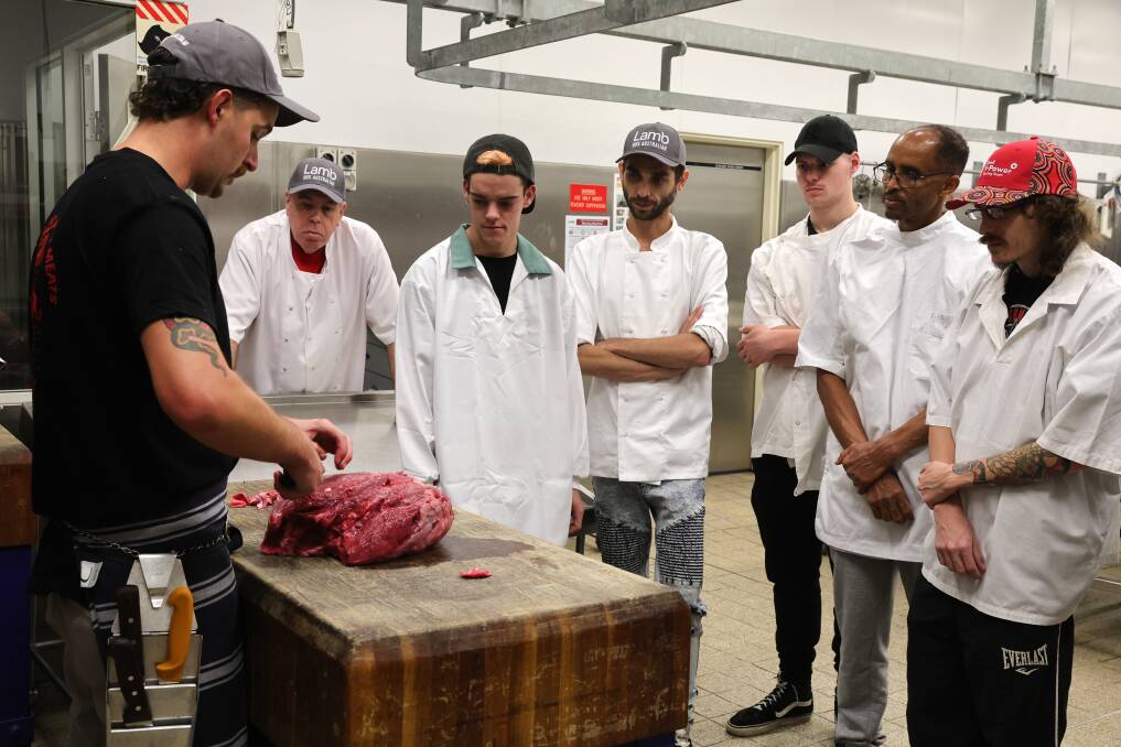 Lachlan Kerr from Cleaver and Co Quality Meats demonstrating how to break down a knuckle. Picture by Sylvia Liber