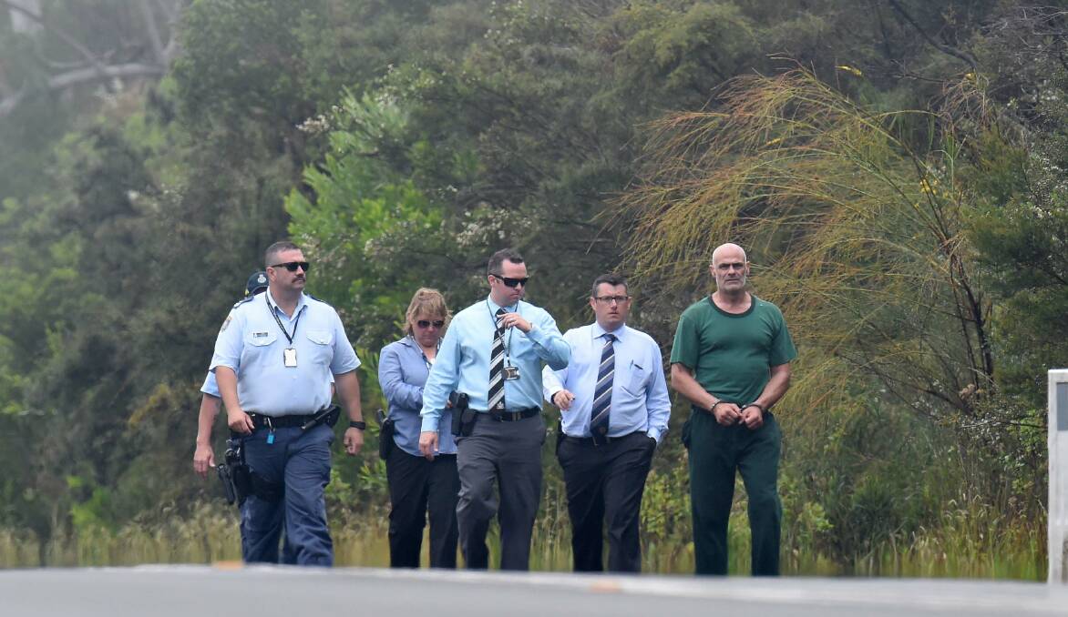 NSW Police escort Vinzent Tarantino (right), who is accused of the murder of Quanne Diec, along Appin Road near Bulli in November. Photo: AAP/Dean Lewins