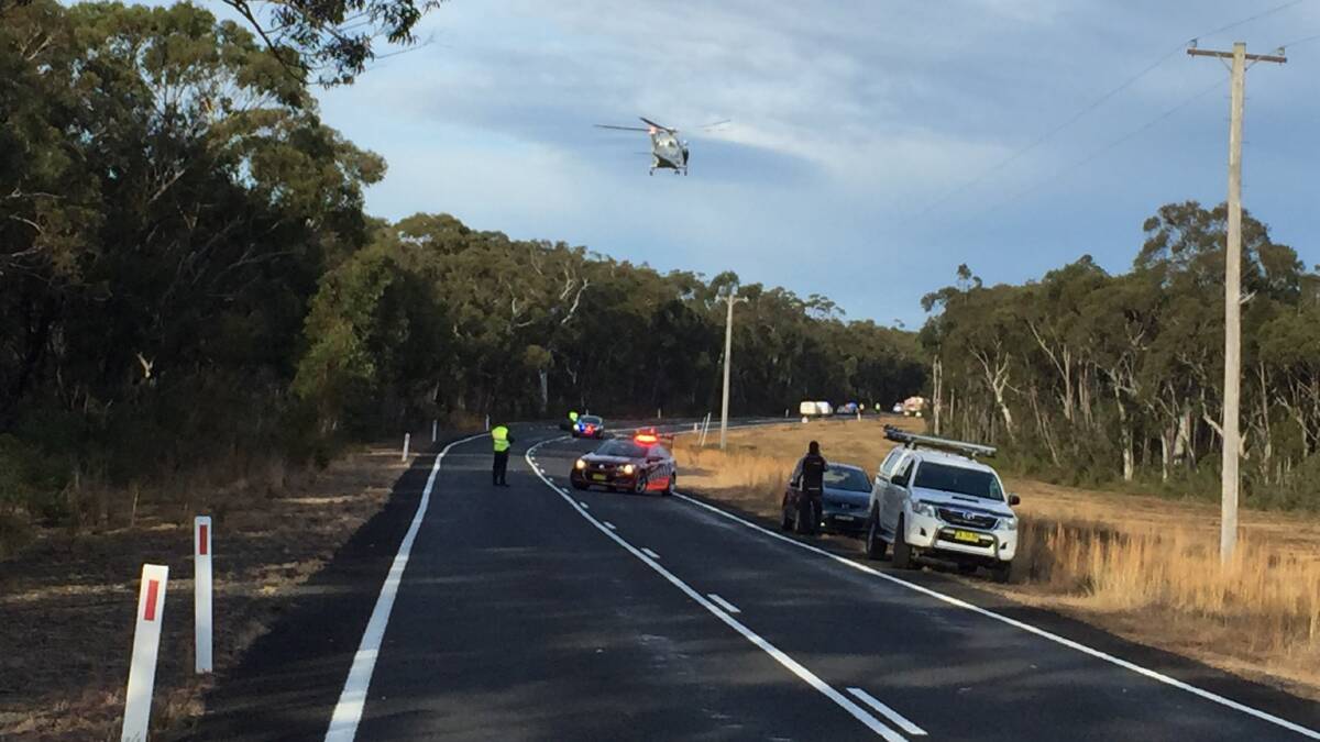 CRASH SITE: The Toll ambulance helicopter comes in to land on Braidwood Road. Picture: South Coast Register