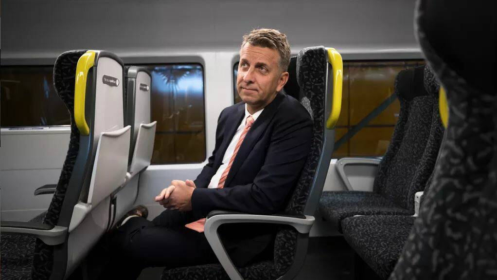 Transport Minister Andrew Constance says the fixed seats allow passengers to have features such as tray tables and charge points for mobile phones. Picture: Janie Barrett
