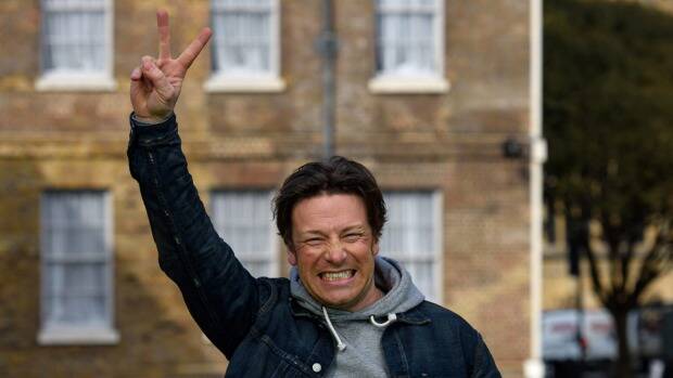 Jamie Oliver celebrates after the announcement of a tax on sugary soft drinks in the UK. Photo: Getty Images/Ben Pruchnie
