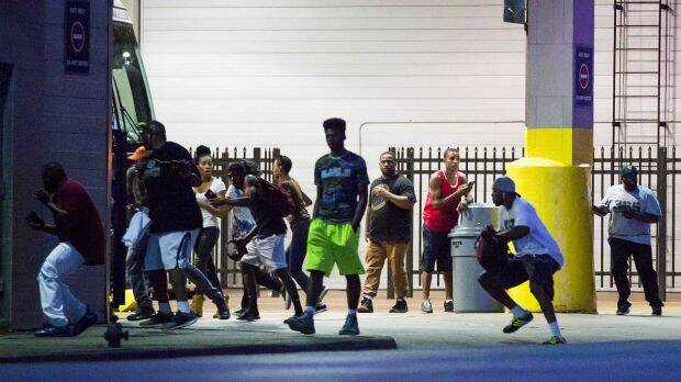 Bystanders run for cover after shots fired at a Black Live Matter rally in downtown Dallas. Photo: Smiley N. Pool