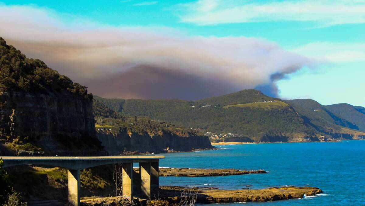 Smoke from bushfire is seen from south of the Sea Cliff Bridge. Picture: Georgia Matts