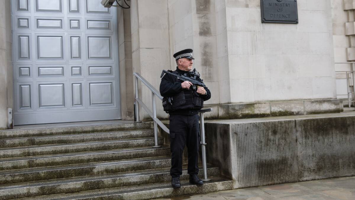 An armed police officer stands guard outside the Ministry of Defence. Picture: GETTY IMAGES