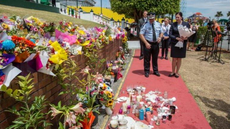 Queensland Premier Annastacia Palaszczuk and Assistant Commissioner Brian Codd pay their respects at Dreamworld on Thursday. Photo: Glenn Hunt