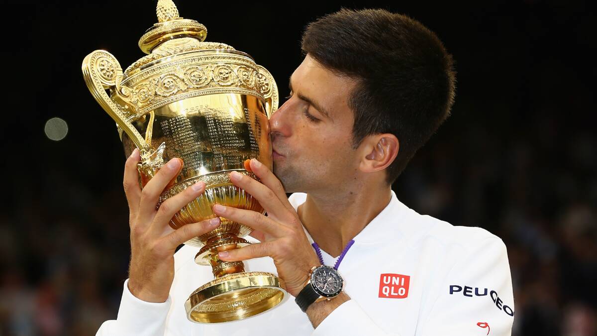 Novak Djokovic of Serbia celebrates with the trophy after winning the Final Of The Gentlemen's Singles against Roger Federer at Wimbledon in 2015. Picture: Getty.