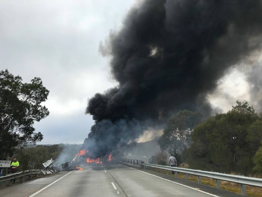 The fully ablaze truck on the Wingecarribee River Bridge along the Hume Motorway on Wednesday morning. The northbound lanes are expected to remain closed until noon on Friday. Picture: NSW Rural Fire Service, Facebook