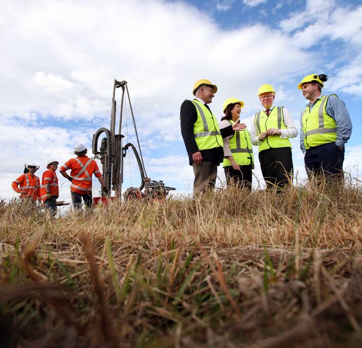 drill down: Lord Mayor Gordon Bradbery, Shellharbour MP Anna Watson and Parliamentary Secretary for the Illawarra Gareth Ward inspect drilling for the Fowlers Road bridge. Picture: Sylvia Liber
