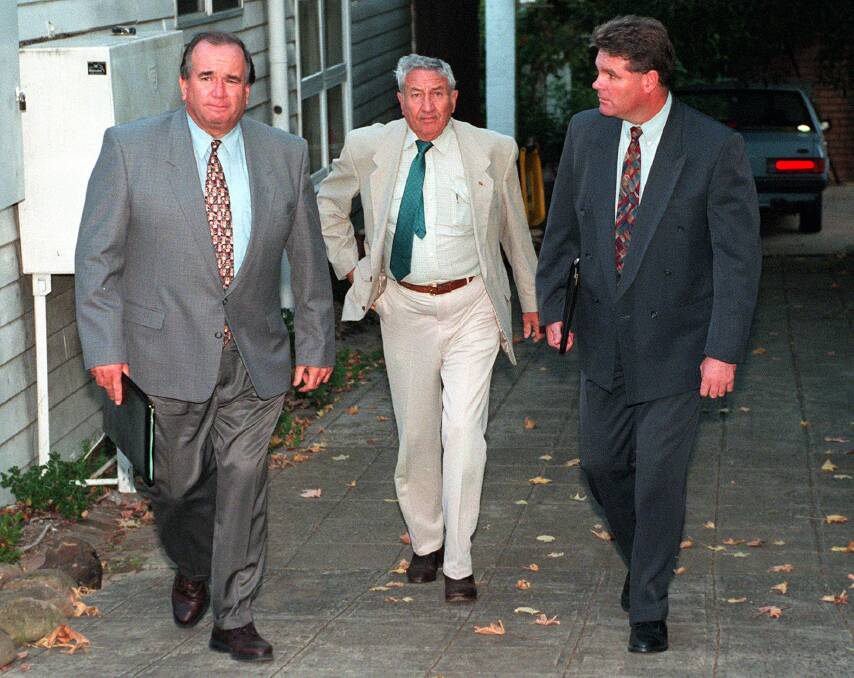 Police detectives arresting Arkell at his West Wollongong home in May 1997, later charging him with numerous sex offences. Picture by Kirk Gilmour