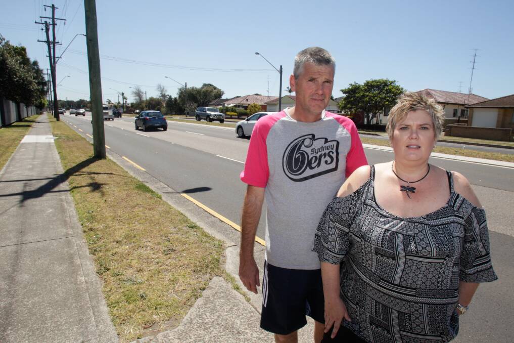 Windang Road residents Dean Bendall and Alison Louth say some motorists treat the road like "a drag strip". The NSW government is looking to improve safety on the road. Picture: Georgia Matts