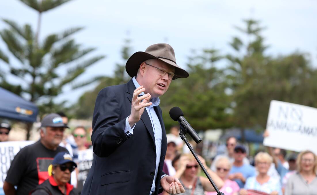 Parliamentary Secretary for the Illawarra Gareth Ward, seen here addressing an anti-merger rally in Shellharbour, is facing criticism that he has "failed" the region.