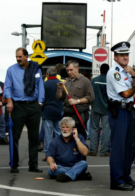 Unionist Wayne Phillips takes a seat at the entrance to the Port Kembla steelworks during a 2004 strike.