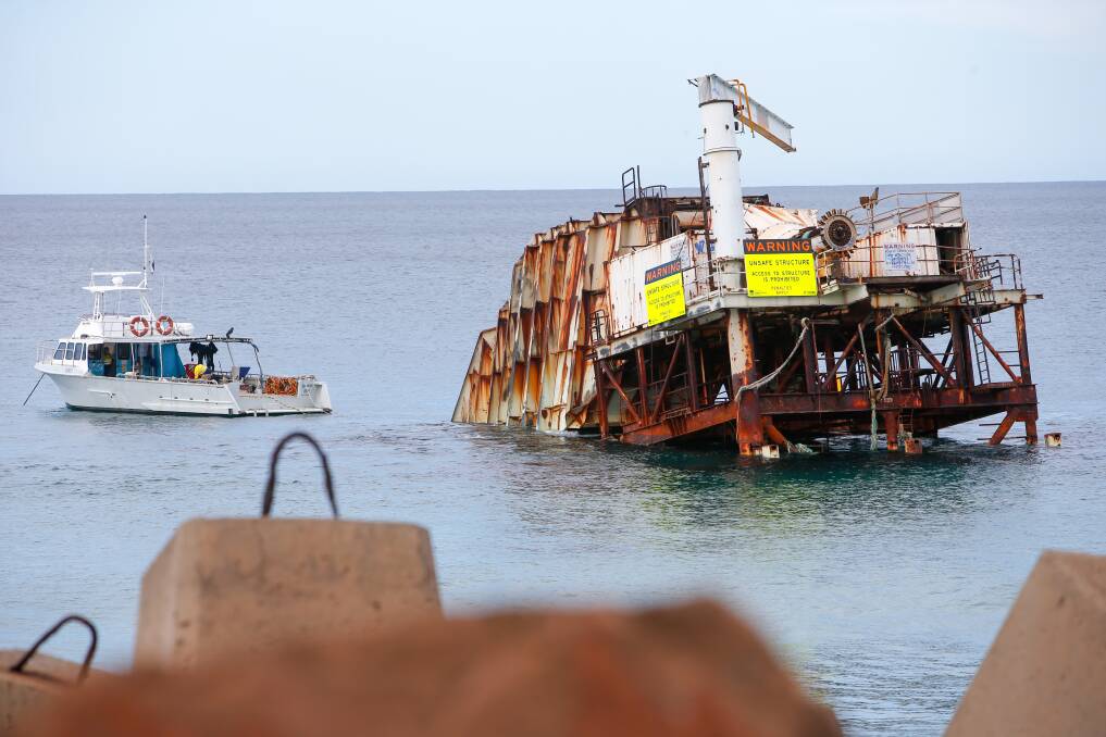The unsightly rusting hulk that is the Oceanlinx wave energy barge will be removed by April. Picture: Adam McLean