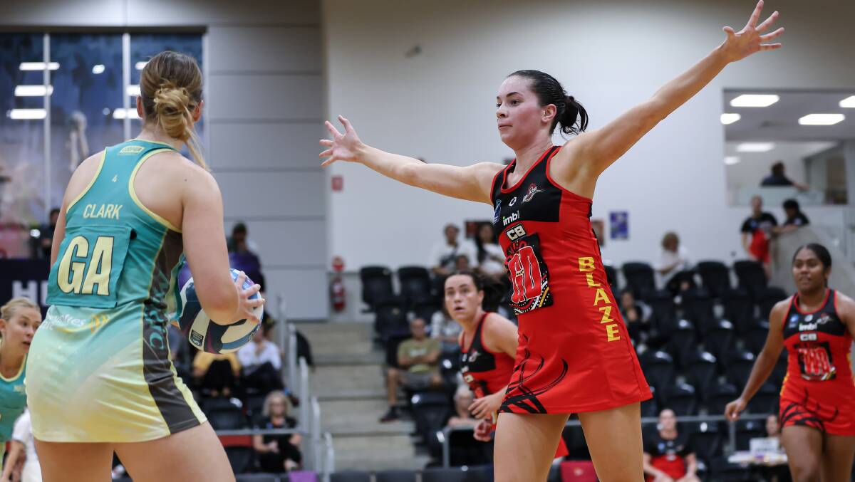 Tegan Holland looks to defend against a Mounties opponent during a recent game for South Coast Blaze. Picture by May Bailey/Clusterpix Photography