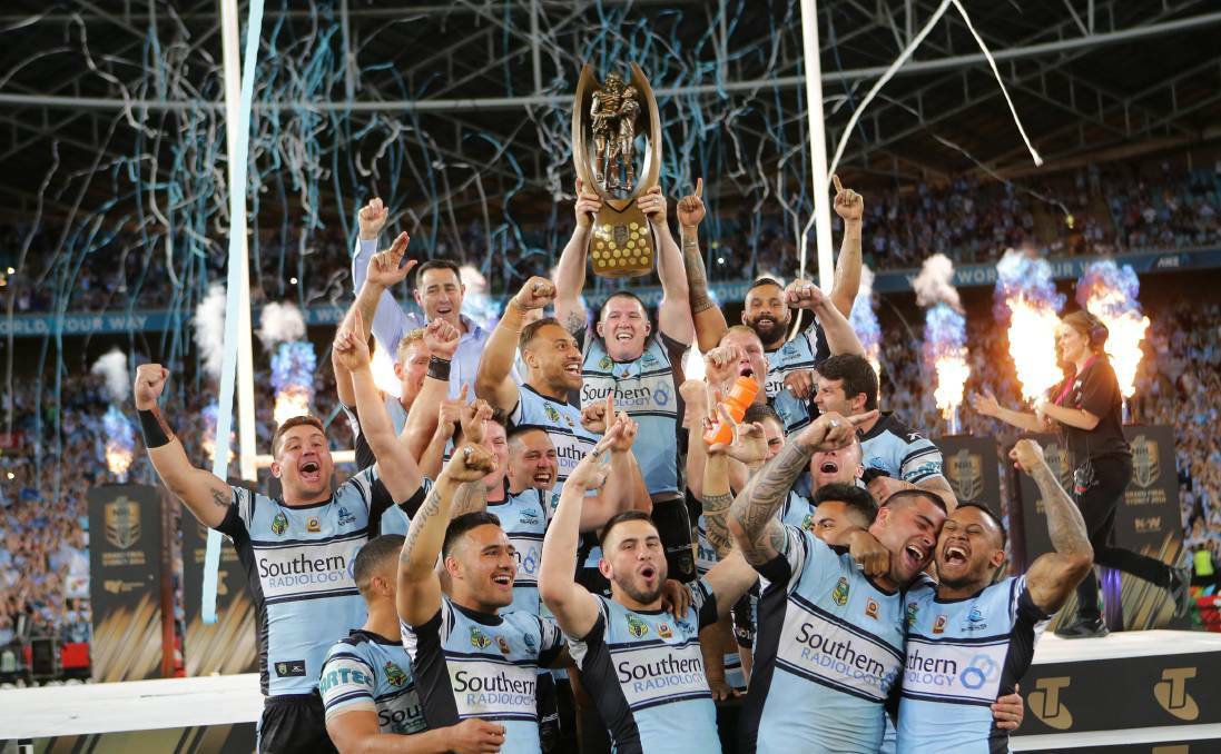 The Cronulla Sharks celebrate after winning the 2016 NRL grand final. Photo: John Veage