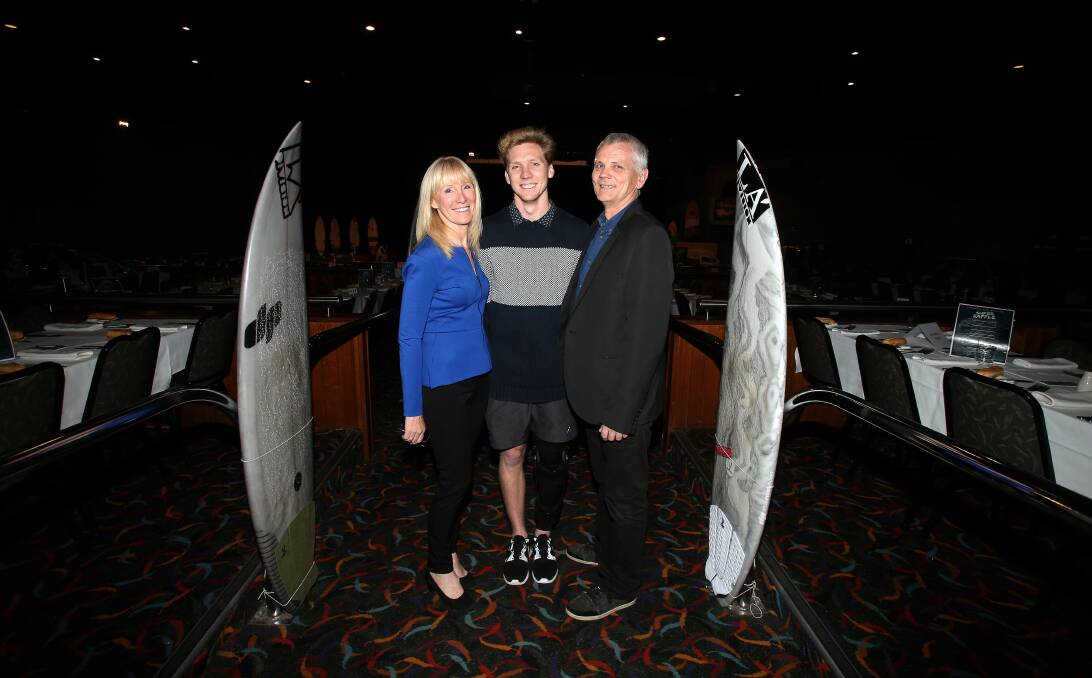 Survivor: Brett Connellan with his parents Gail and Mal Connellan at Saturday night's fundraiser organised by some of his mates and the Jones Beach Boardriders to help ease the financial pain of his rehabilitation. Picture: Sylvia Liber