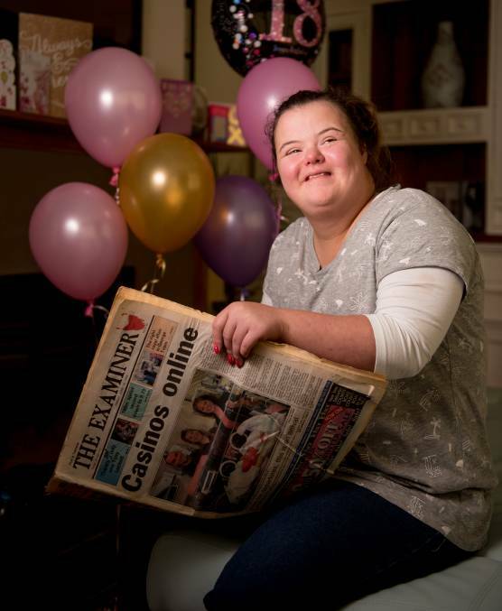 CELEBRATE: Eighteen-year-old Colby Withers with a copy of The Examiner, from 1999, when she was front-page news. Picture: Scott Gelston 