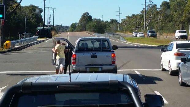 A man punches a woman after an apparent road rage incident on the NSW central coast. Photo: Dash Cam Owners Australia
