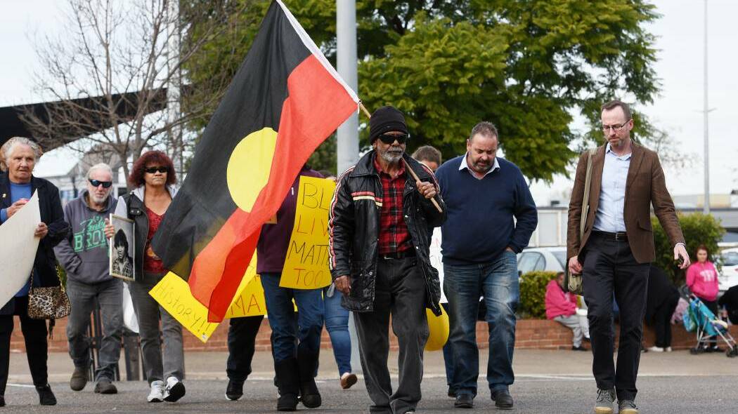 Don Craigie leads family and friends of Mark Haines to the Tamworth Police station to demanding action on the cold case. Photo: Gareth Gardner