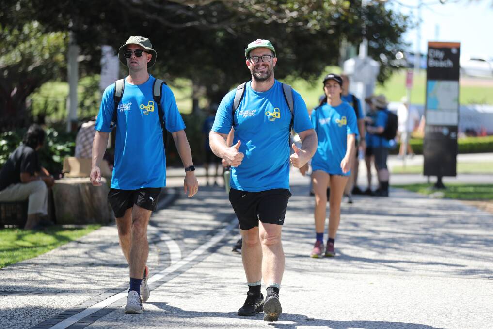 Walkers in bright blue lined the footpaths from Shellharbour to Austinmer. Picture by Robert Peet