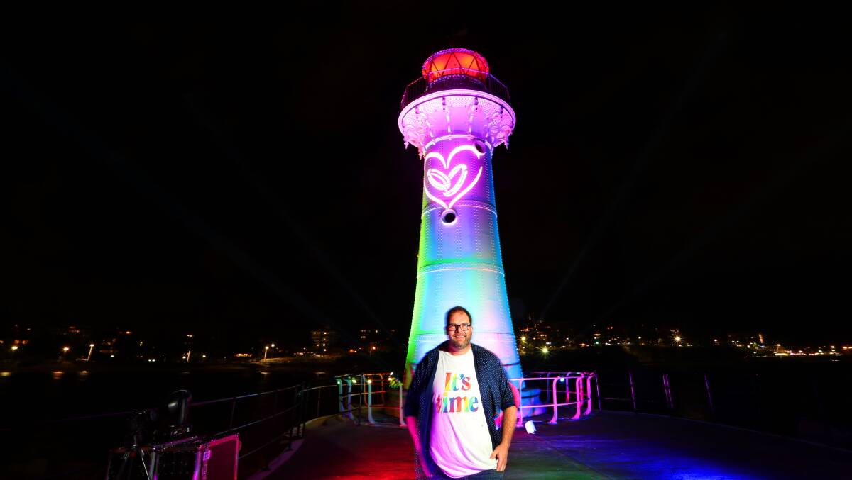A beacon of hope: Equality campaigner Simon Zulian hopes the rainbow colours on Wollongong's breakwater lighthouse will shine the way for Wednesday's survey results. Picture: Sylvia Liber.