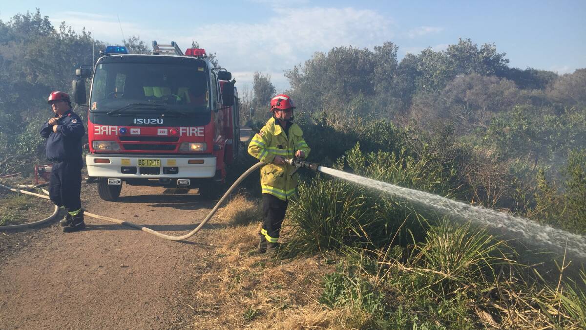 Crews fight the scrub fire in hot condition. Picture: Robert Peet