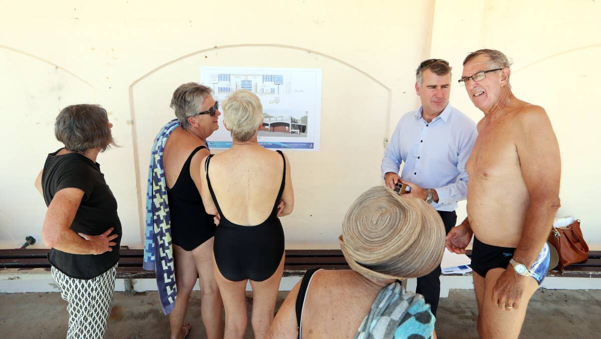 Changing rooms: Mark Roebuck, of Wollongong City Council, chats to regulars at Austinmer Beach about the proposal (above) for the amenities block. Picture: Sylvia Liber. 