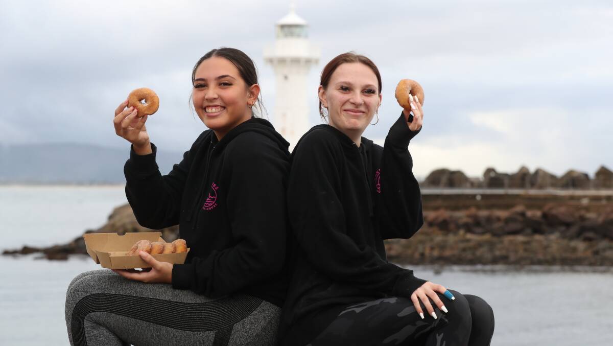 Maddison Sanchez and Britney Grpcevski with donuts from Yachties' Cafe at Wollongong Harbour. Picture byRobert Peet