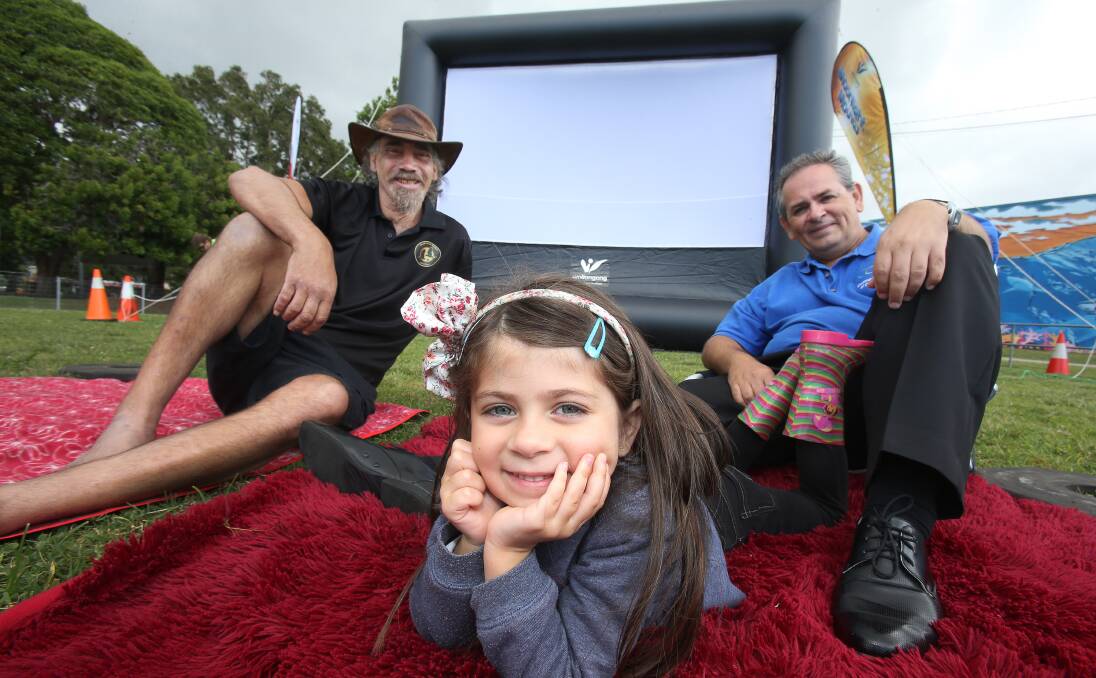 Movie time: Corrimal Chamber of Commerce president Paul Boultwood and Keira Boultwood with Fred from Fred's Bush Tucker prepare for the council's Moonlight Movies to be held at Memorial Park. Picture: Robert Peet.