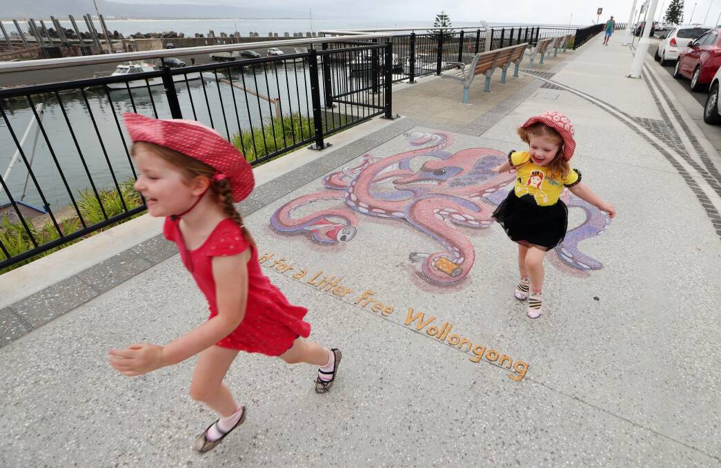 Colourful reminder: Each 3D chalk mural  - like this one on Endeavour Drive which captured the attention of Felicity and Chloe Baker on Monday - comes with a message to "Bin it for a litter free Wollongong". Pictures: Sylvia Liber.