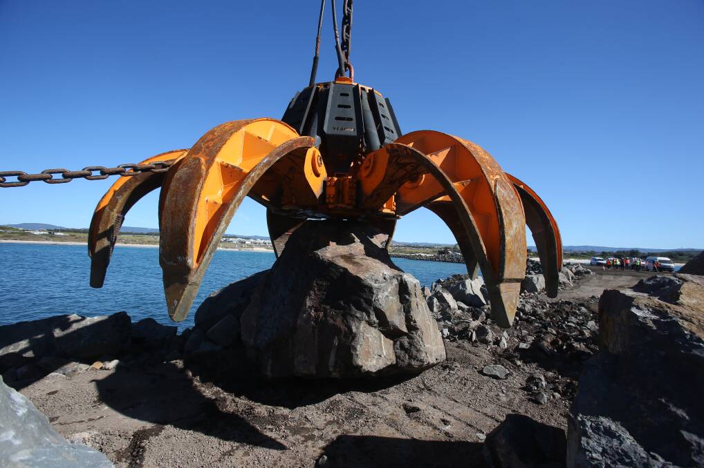 Rock on: Boulders weighing up to 30 tonnes were lifted onto the furthermost point of the breakwall on Thursday.