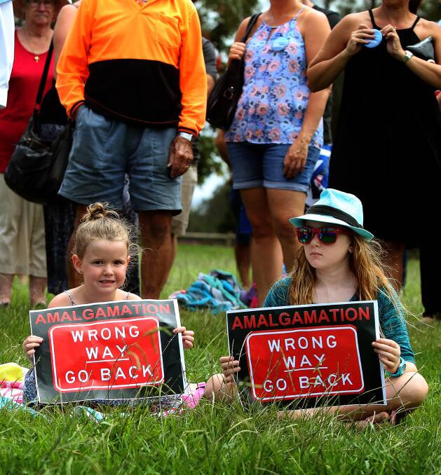Signs of discontent: Sienna and Emily Owers at last month's community rally in Shellharbour. Picture: Sylvia LIber.