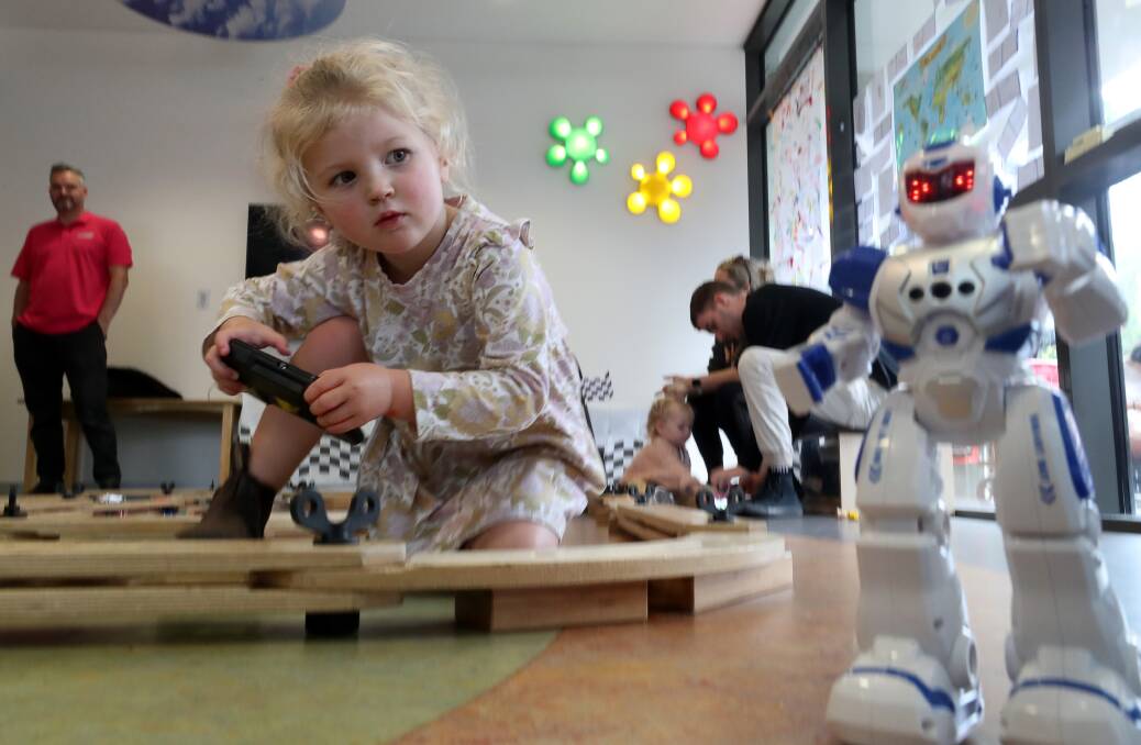 Kiama's Lakey Watson, three, plays with a robot at the Festival of Digital Play at Early Start. Picture by Robert Peet