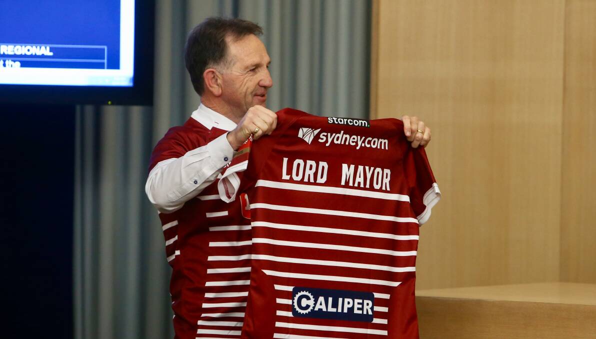 Liberal councillor John Dorahy (and mayoral hopeful) presented a Wigan Warriors jersey to the city - and whoever becomes Lord Mayor under the next council - after last week's announcement that the English Super League team will play at WIN stadium in February.
