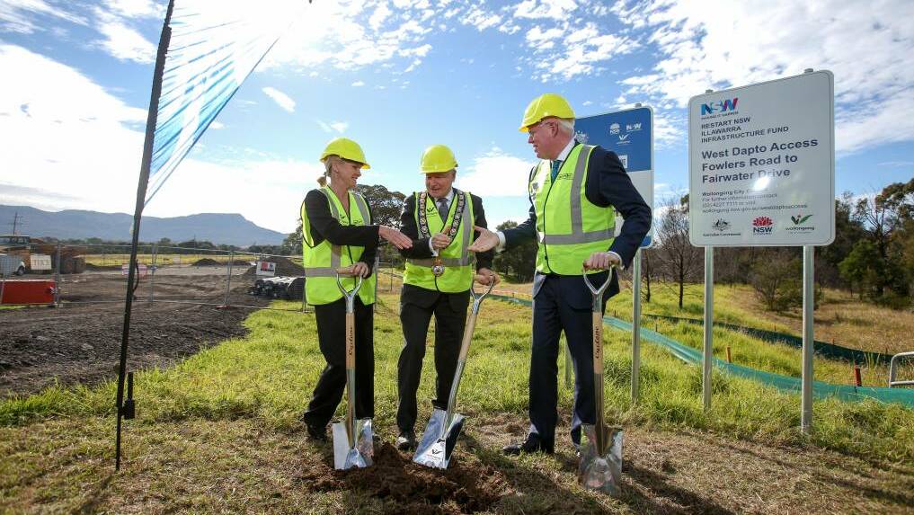Federal Minister for Regional Development Fiona Nash, Wollongong Lord Mayor Gordon Bradbery and Kiama MP Gareth Ward turn the first sod for the first stage of Fowlers Road last July. Photo: Adam McLean
