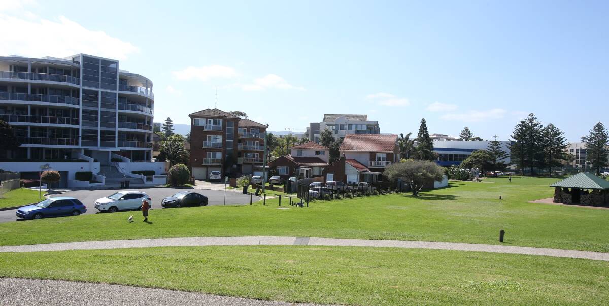 Development site: The proposed eight-storey building, planned to replace these two red brick homes (centre), would rise above its neighbours at Lang Park. Picture: Robert Peet