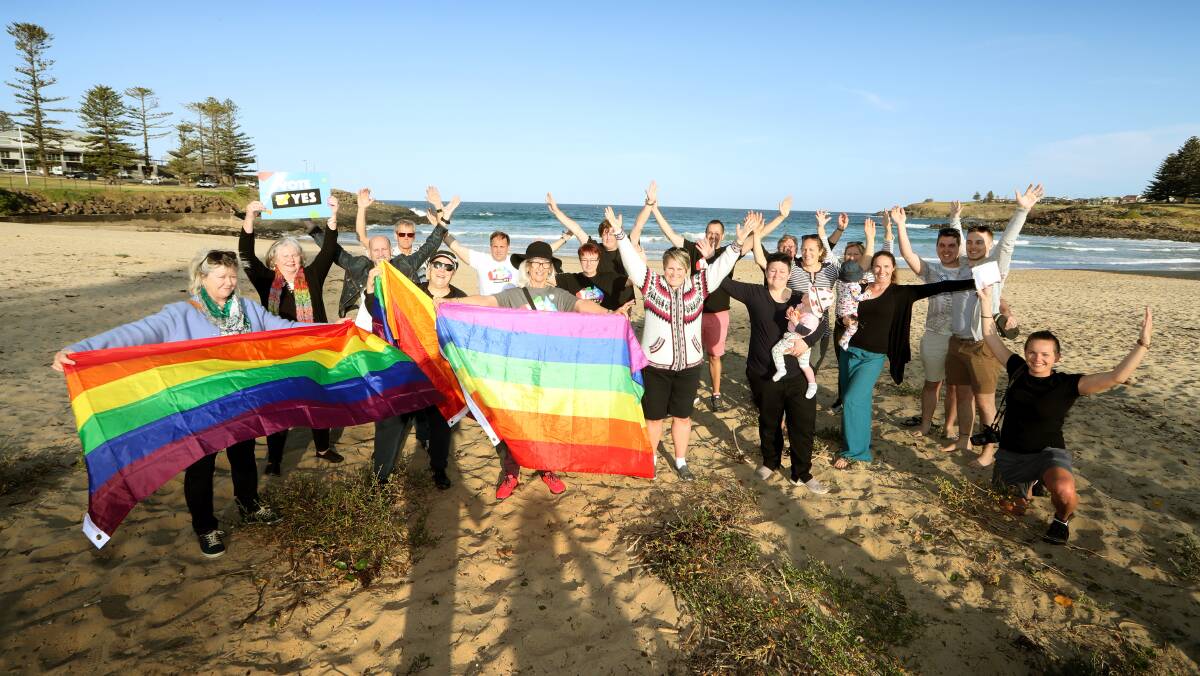 SUPPORTING EQUALITY: Some of the Y-E-S group gathered on the beach after the formation to fly their rainbow flags. Picture: Sylvia Liber.