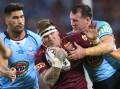 Josh McGuire of the Maroons is tackled during game two of the State Of Origin series between the Queensland Maroons and the New South Wales Blues. (Photo by Chris Hyde/Getty Images) 