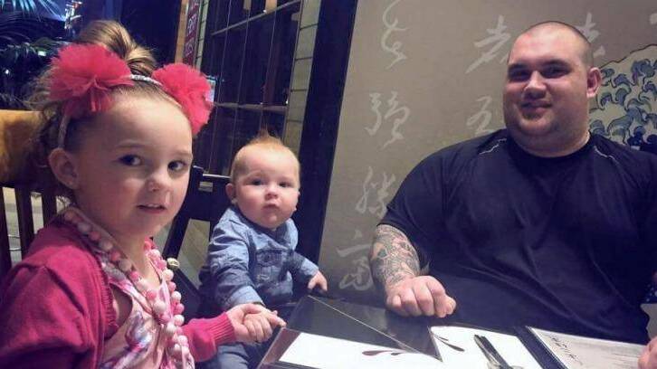 Mitch Jackson is one of the Good Samaritans who went into the burning Springvale Commonwealth Bank to help rescue people. With his children, Ava, 6, and Kai, 2. Photo: Supplied