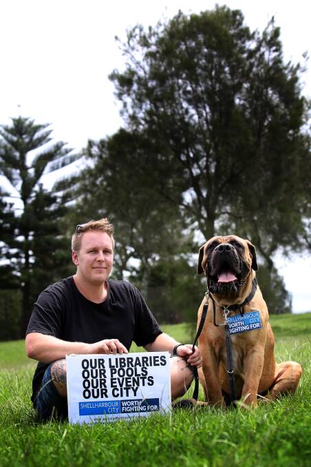 Fighting: Adam Cox and his 4yr old Boerboel mastiff Andrew don't want Shellharbour and Wollongong councils to merge.