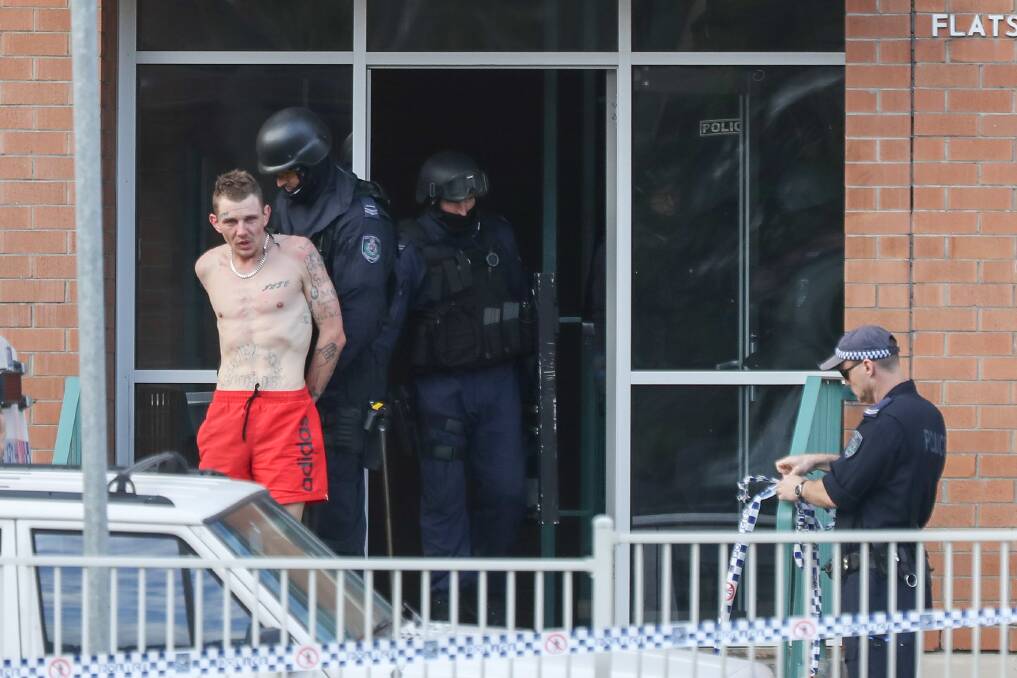 Jarrod Short is arrested by tactical police following a four-hour siege at Warrawong on Thursday.