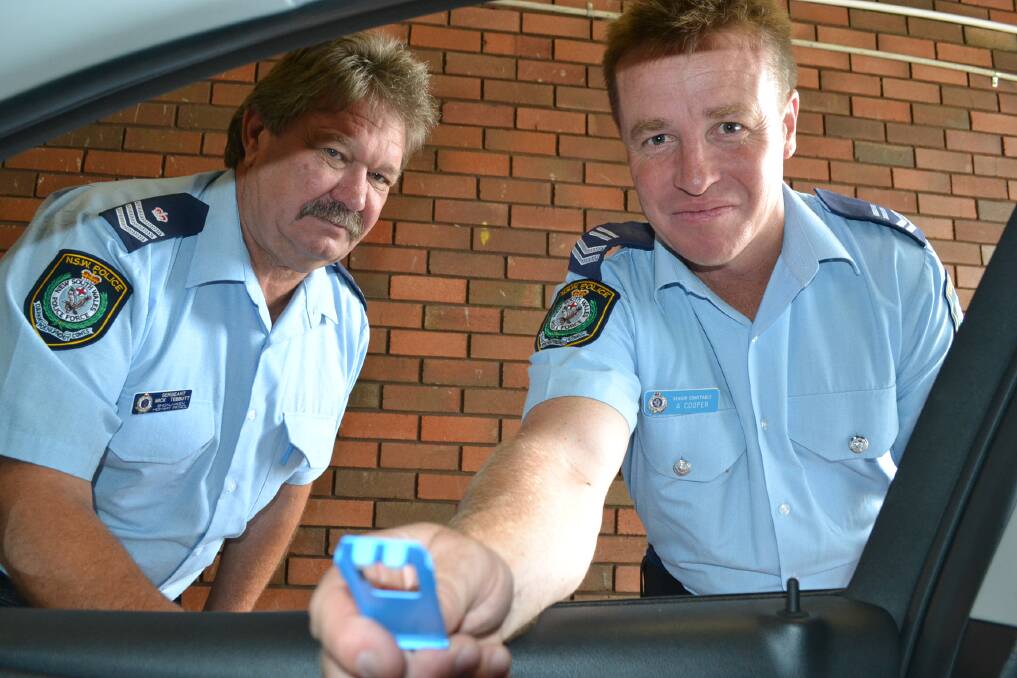 ON THE ROAD: Sergeant Mick Tebbutt (left) and Leading Senior Constable Adam Cooper with the mobile drug testing equipment.