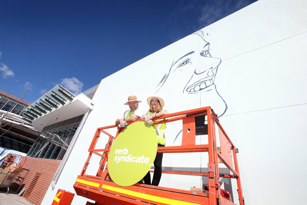 Mikey Freedom and Claire Foxton are completing a giant mural this weekend, adding some vibrancy to the new dining precinct at Stockland Shellharbour. Picture: Sylvia Liber