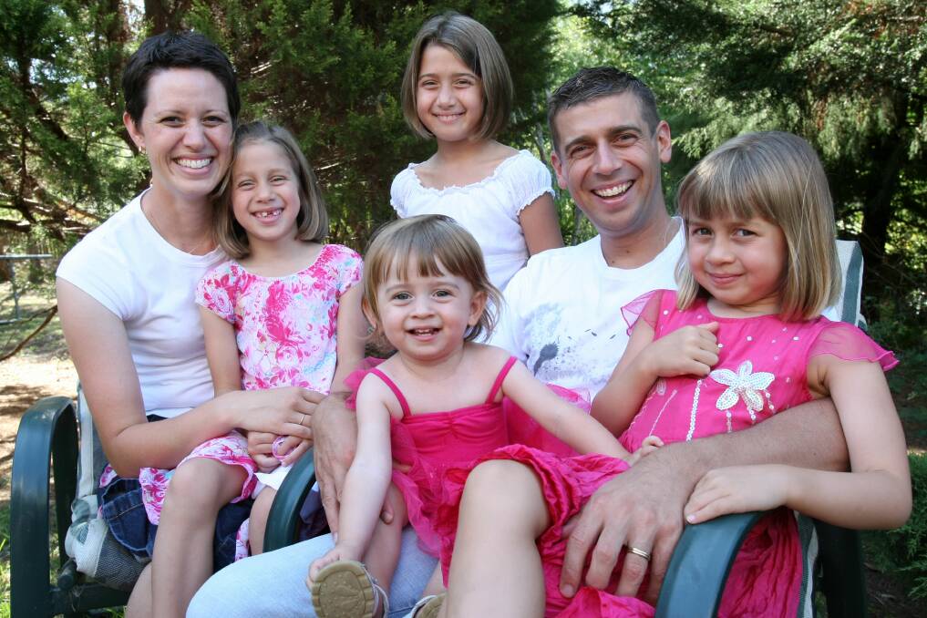 FLASHBACK: Dr Justin Coulson and his family in 2009. The psychologist says having a constant happy family is one of the biggest misconceptions people have, as research suggests kids and happiness don't mix well together. Picture: Ken Robertson