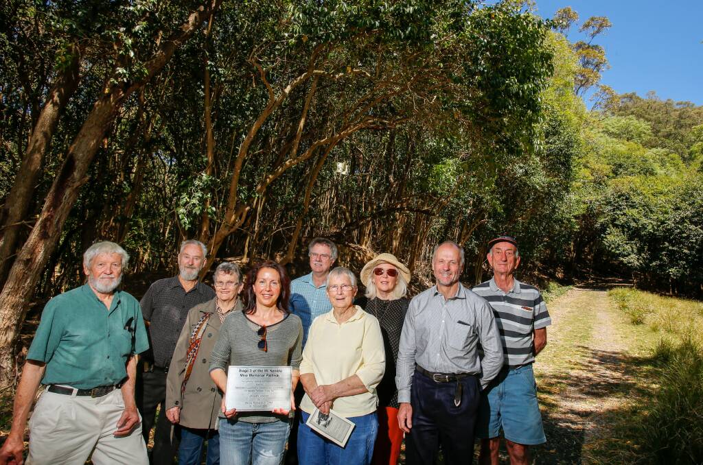 Members of the Memorial Pathway Group and the official plaque at the completed Mount Kembla Memorial Pathway. Picture: Adam McLean