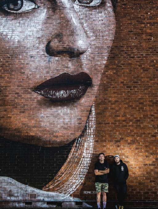 WONDER WALLS: Artist Mitch Guerin and Wonderwall co-founder Simon Grant in front of a painting by Melbourne artist Rone, from the 2012 festival. Picture: Christopher Chan