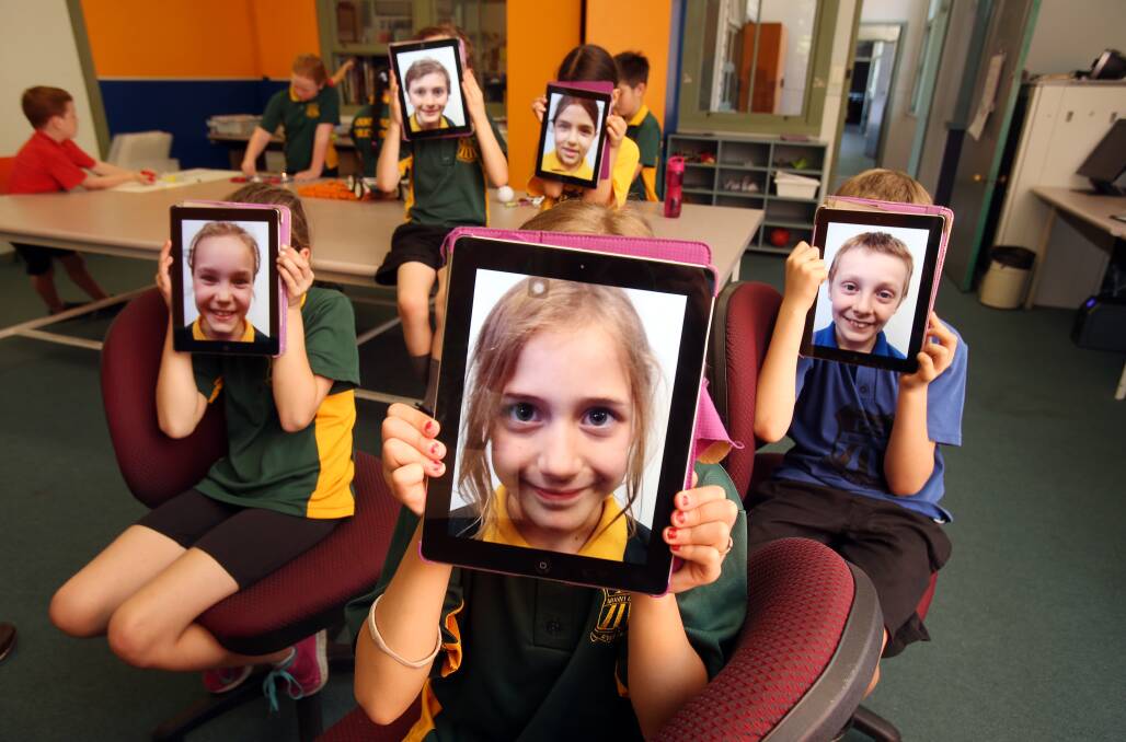 SAVVY: Mount Ousley Public School students Amelia Rackham, Alexis Piazza, Zach Silver, Sama Sabbar and Eli Cater-Rodda - the primary school is the latest in the Illawarra to bring in iPads for K-6 students. Picture: Robert Peet