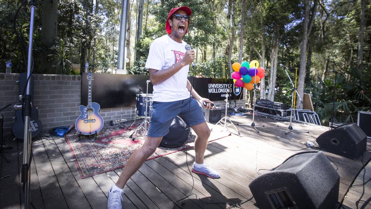 Triple J's Matt Okine sings karaoke on the UOW lawn stage - part of theirr O-Mazing Race challenge. Picture: Supplied